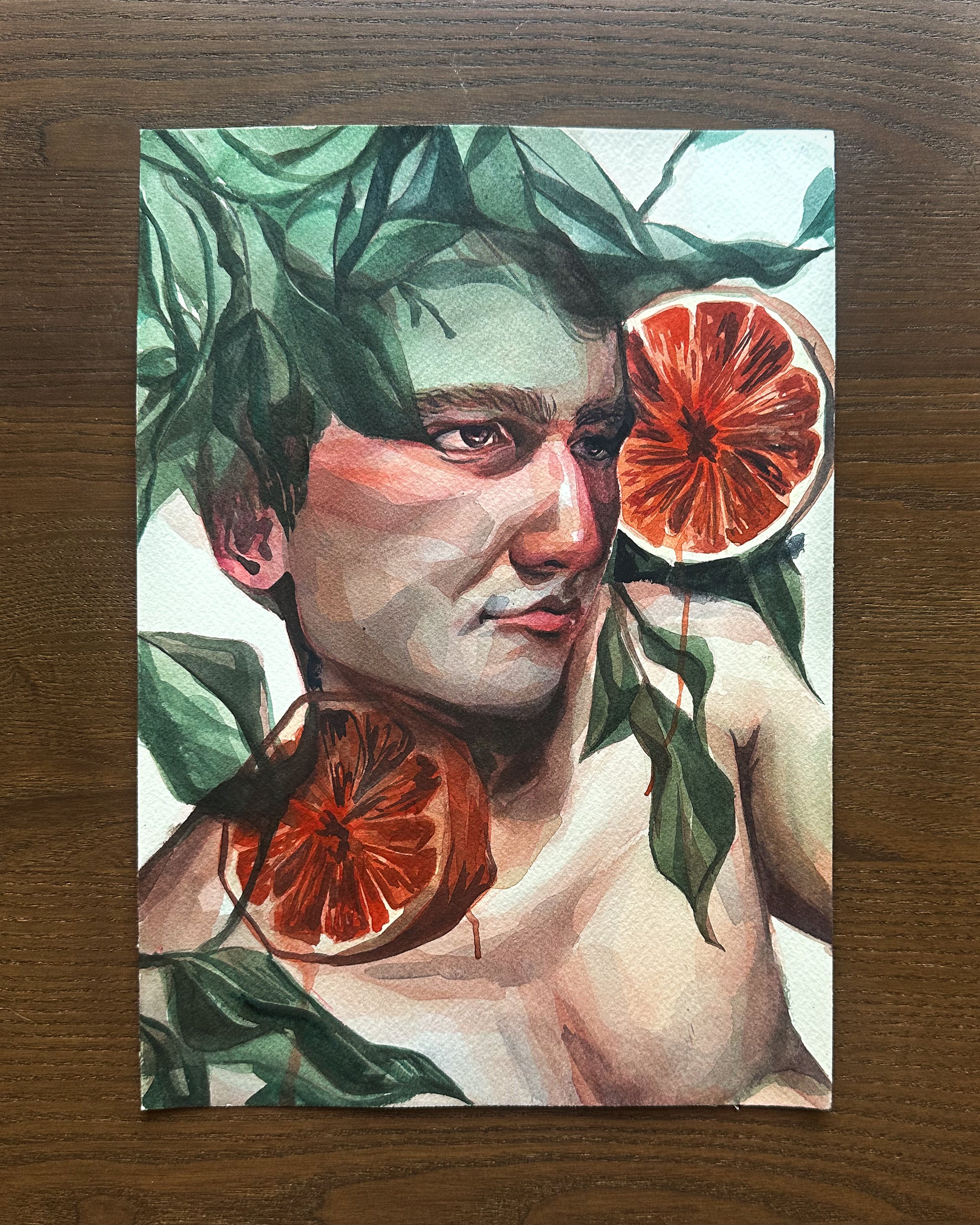 Artistic depiction of a person with grapefruit and leaves on a wooden surface.